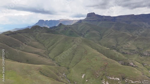 Aerial Sweep Across Classic Drakensberg Skyline With Layered Escarpments And Green Folds, Documentary Crew