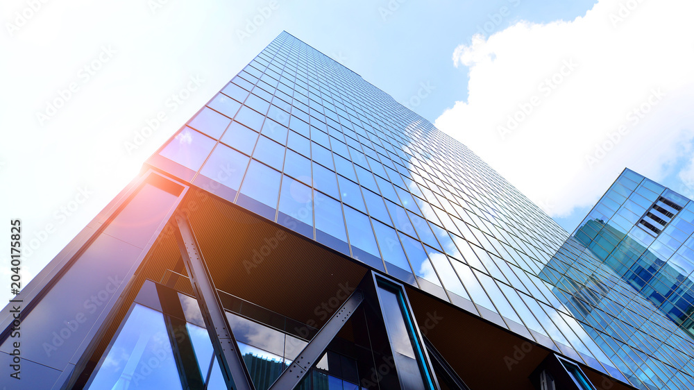 Obraz premium Steel and glass. The subject of modern architecture or construction industry. Modern office building facade with tall steel construction elements and full height windows between.