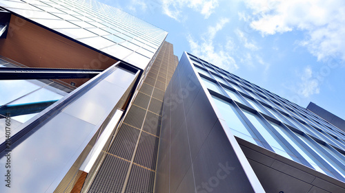Steel and glass. The subject of modern architecture or construction industry. Modern office building facade with tall steel construction elements and full height windows between.