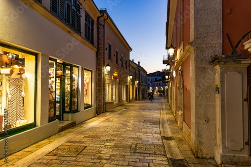 Atmospheric evening street illuminated by lanterns in the old town of Herceg Novi