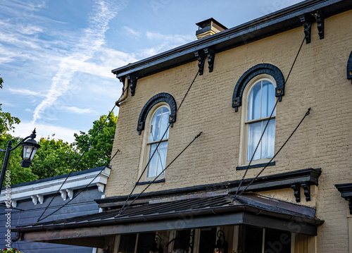 Building visor supported by trusters on historic two-story brick building