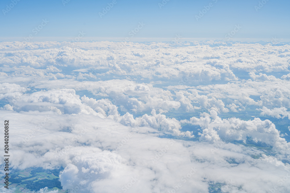 Naklejka premium Flying high above clouds covering switzerland landscape
