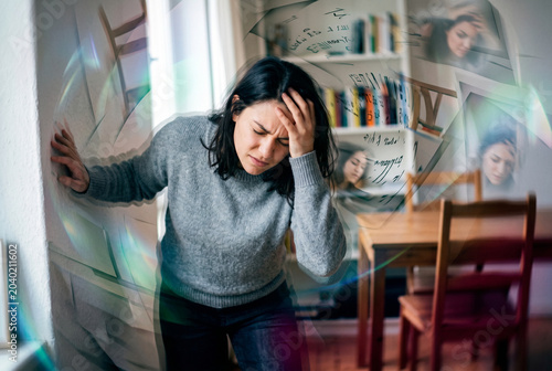 Young woman experiencing severe vertigo and dizziness in apartment