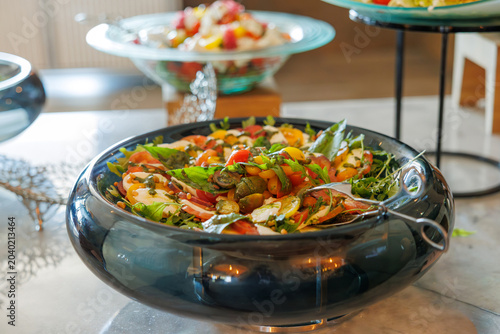 Fényképezés Fresh mozzarella, colorful heirloom tomatoes, fragrant basil: a vibrant Mediterranean buffet salad
