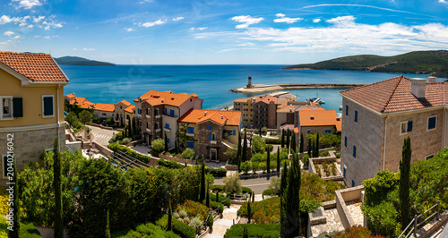 Upscale stone villas and elegant coastal architecture of the exclusive Lustica Bay luxury resort community. Montenegro
