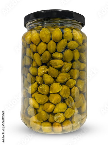 Pickled or brined capers in a glass jar isolated, featuring flower buds typical of Mediterranean cuisine