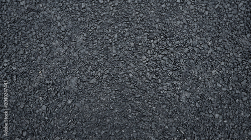 High resolution dark grey asphalt texture featuring rough granular road surface for construction civil engineering and urban pavement design themes