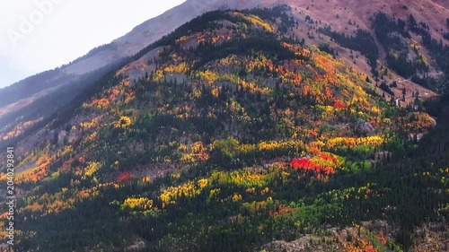 Panoramic aerial view of Colorado fall landscapes along Million Dollar Highway with views of mountainside fall foliage trees in San Juan Mountains during autumn season - 4K Drone