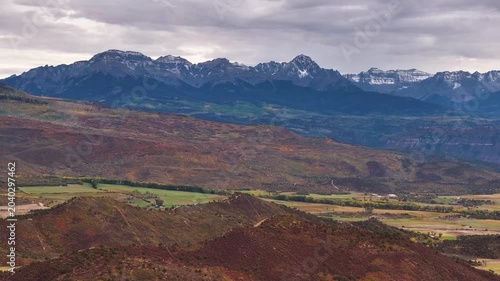 Panoramic aerial view of Colorado fall landscapes featuring mountain peaks and fall foliage while capturing the beauty of Dallas Divide in the San Juan Mountain national forest wilderness - 4K Drone