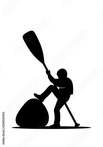 Person standing with a paddle by a boulder