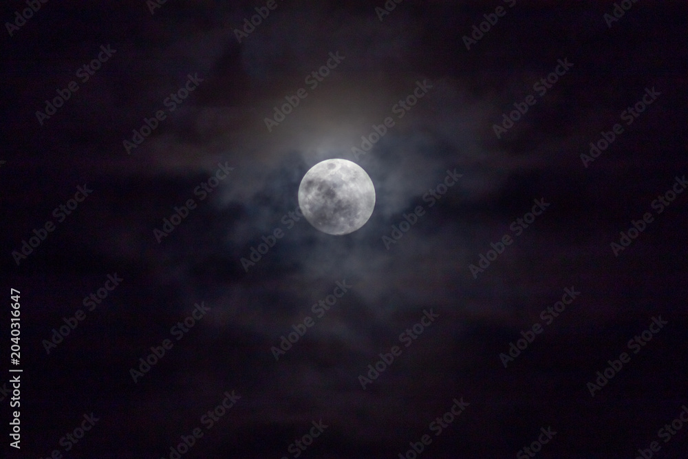 Fototapeta premium Full moon in the night sky with clouds