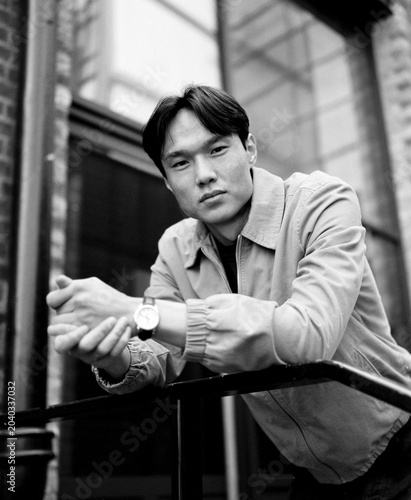 Young asian man posing urban retro film portrait