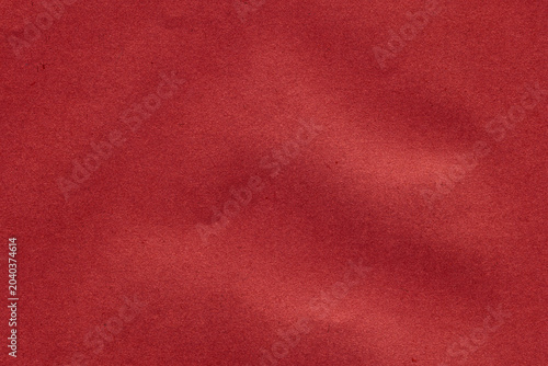 Coral red paper texture with smooth finish and natural tonal variations. Abstract background ideal for graphic design, branding and creative projects.