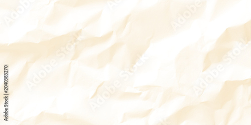 Soft cream colored crumpled paper texture background with gentle folds and creases for design and decoration
