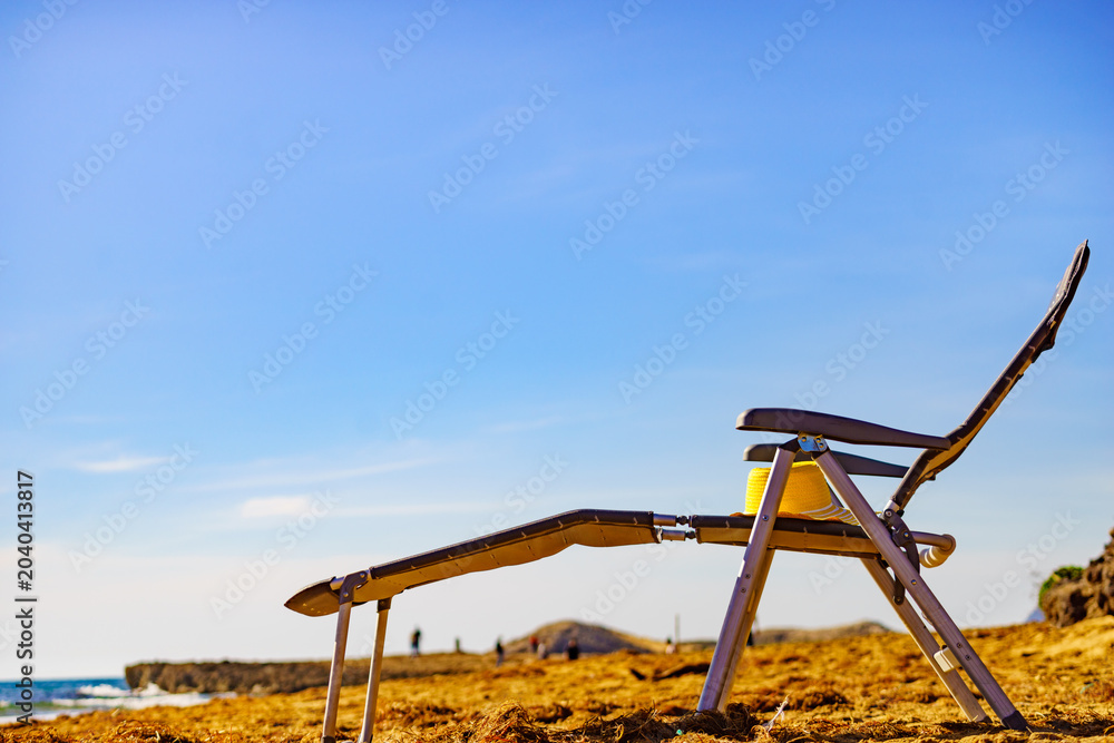 Fototapeta premium Deckchair on sandy beach