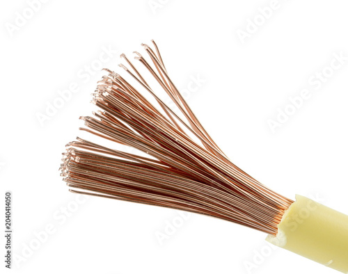 Macro shot of fanned copper wires from a cut cable, yellow plastic insulation, white background
