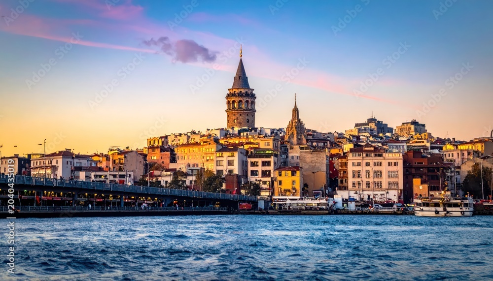 Fototapeta premium Istanbuls Iconic Skyline - A Captivating View of Historic Landmarks and Architectural Marvels at Sunset.
