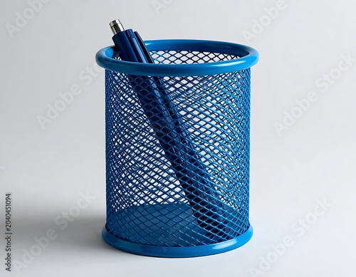 A blue mesh pencil holder with a pen inside