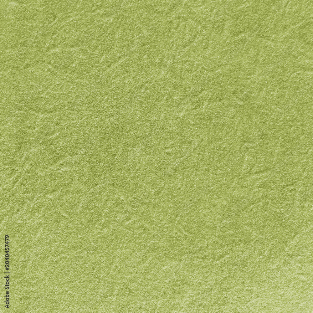 Obraz premium Textured green paper background with a crumpled, organic appearance.