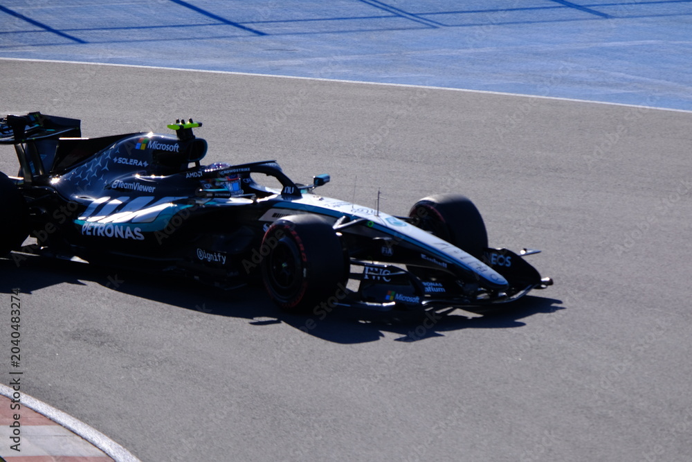 Naklejka premium May 24, 2026, Montreal, Canada, Mercedes F1 car racing through Circuit Gilles Villeneuve corner. g.