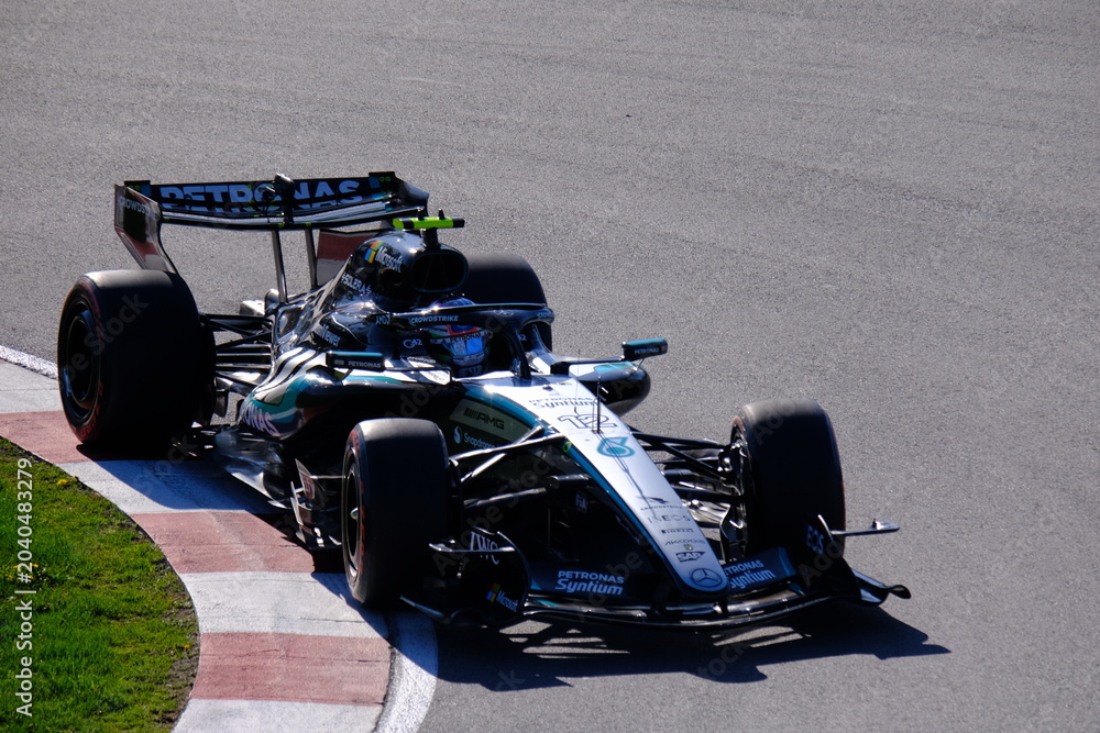 Naklejka premium May 24, 2026, Montreal, Canada, Mercedes F1 car racing through Circuit Gilles Villeneuve corner. g.