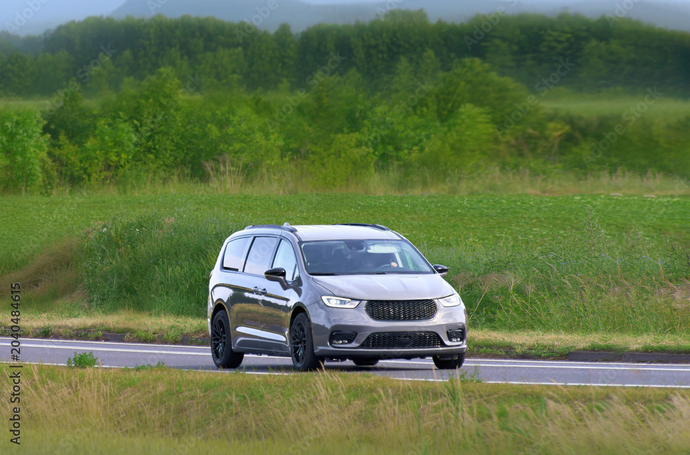 Fototapeta premium Modern MPV family vehicle on scenic rural highway