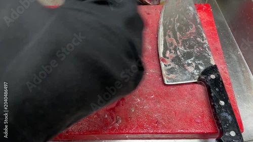 Butcher cleaning a bloody cutting board after work