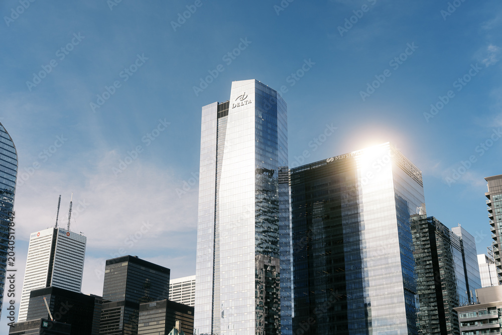 Obraz premium Toronto, Canada - May 26, 2026: Modern glass skyscrapers and Delta Hotel tower in downtown financial district