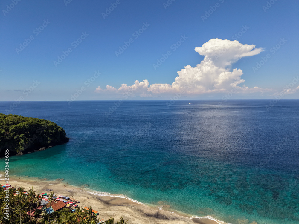 Fototapeta premium High angle view of Virgin Beach with turquoise water and dramatic cumulus clouds, Karangasem, Bali
