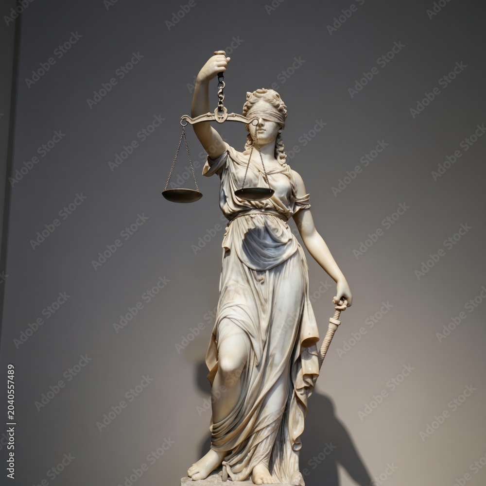 Obraz premium Blindfolded woman statue holds scales of justice and sword. Symbolizes fairness, law, balance, and impartial judgement. Represents legal system truth and order. Classical marble sculpture.