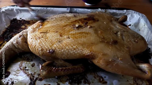 Brushing sauce on baked duck, indoor Chiangmai Thailand.