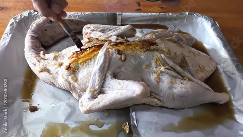 Brushing sauce on baked duck, indoor Chiangmai Thailand.