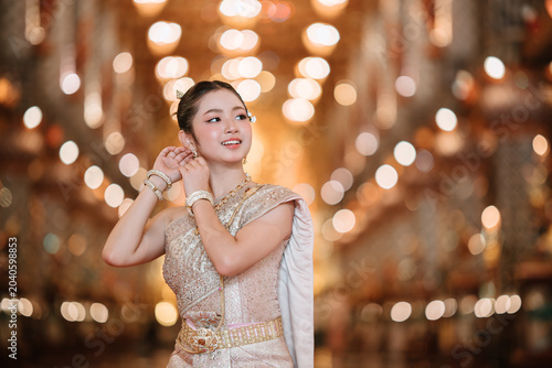 Beautiful Thai Woman in Traditional Costume with Elegant Background