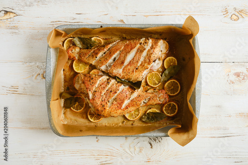Принти на полотні Red snapper baked with lemon and herbs on a baking tray ready for serving