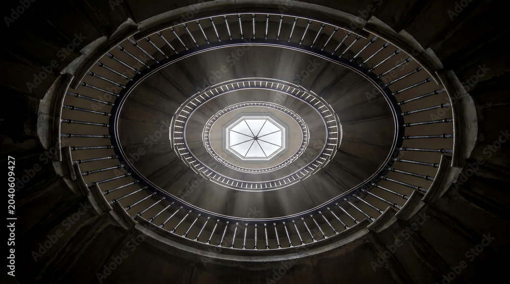 Fototapeta premium Spiral staircase viewed from above with a central octagonal skylight