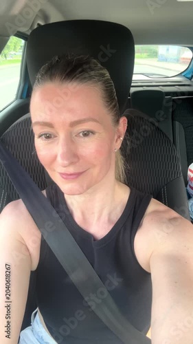 a happy young girl travels by car 