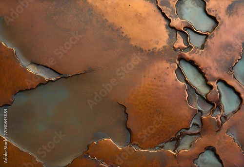 Aged copper metal surface showing natural oxidation with green patina and warm brown textured corrosion.