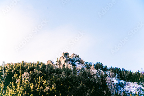 Bild auf Leinwand Landscape of Siberia mountains Stolbi, rock peak range in haze winter