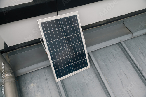 Photos Solar Cell Installation on Home Metal Roof with Drainage Pipe System