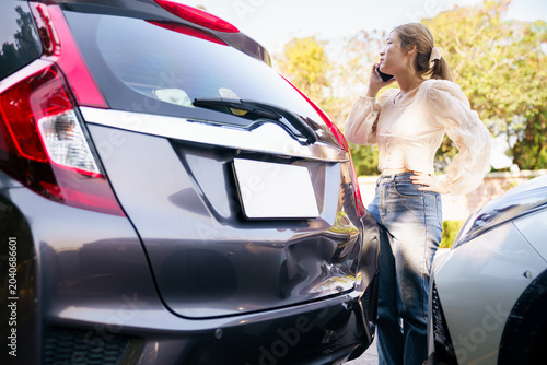 Worried woman calling insurance after a car accident