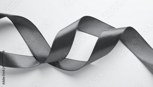Elegant black satin ribbon twisted into a spiral shape on a white background.