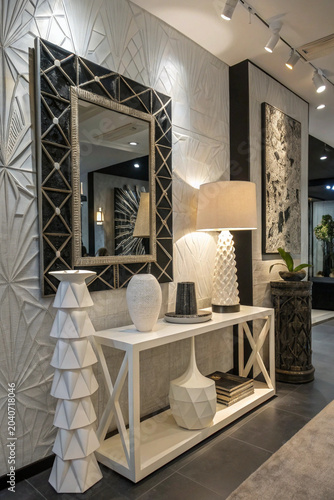 Luxury cubist interior with 3D printed avant-garde furniture, abstract style fragmented mirror, geometric lamps, and matte black white decor