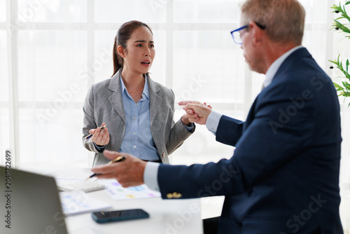 Картината върху платно Asian businesswoman dealing with a stressful workplace conflict and a manager's