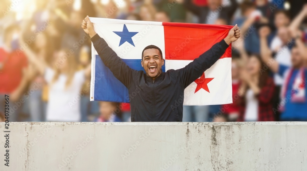 Fototapeta premium Panamanian football fan celebrating with national flag in stadium