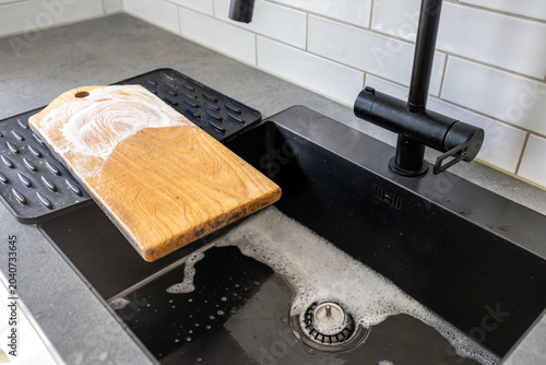 Foto Stockholm, Sweden A wooden kitchen cutting board with soap and water