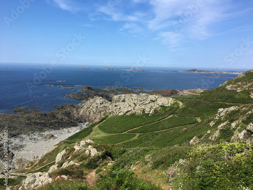 Εκτύπωση καμβά A high-angle, wide shot looking northward along the rugged, green-carpeted cliffs of the Pleinmont headland in the parish of Torteval on the southwestern tip of Guernsey, Channel Islands