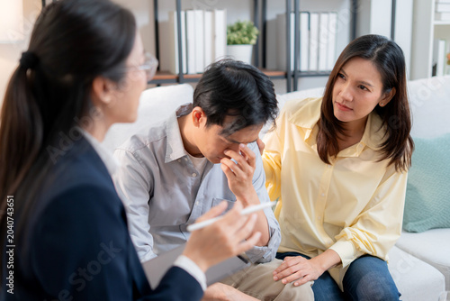 Asian couple therapy counseling and relationship support, mental health, consultation about anxiety, stress and depression, psychologist advising family conflict management, conversation for empathy.