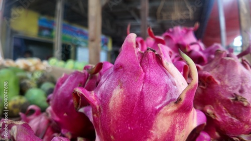 Photo of red dragon fruit skin, which looks like scales