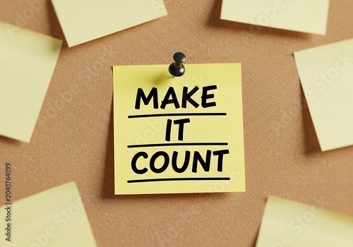 Yellow sticky note on corkboard with inspirational message make it count
