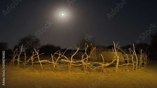 Photos Central Africa, Chad, Night view of a village courtyard with brick huts and wooden light buildings